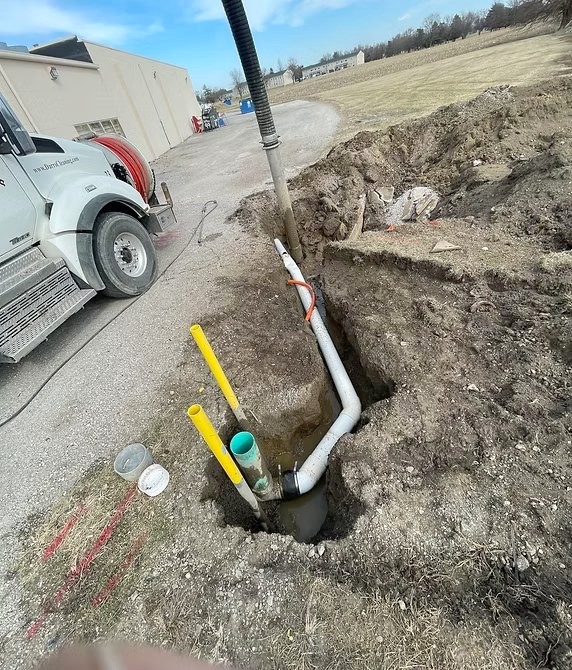 Utility lines exposed intact inside a hydroexcavated pit